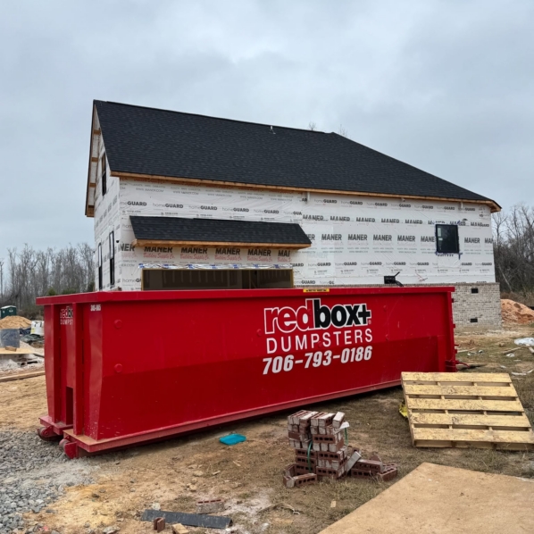 a dumpster at a home construction site