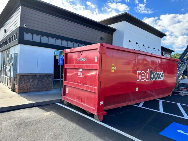 a dumpster outside a commercial construction setting