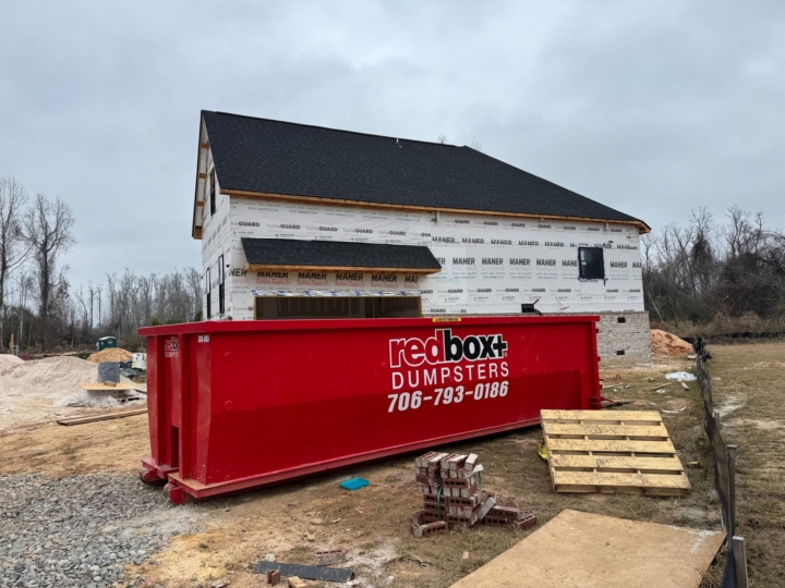 a dumpster at a home construction site