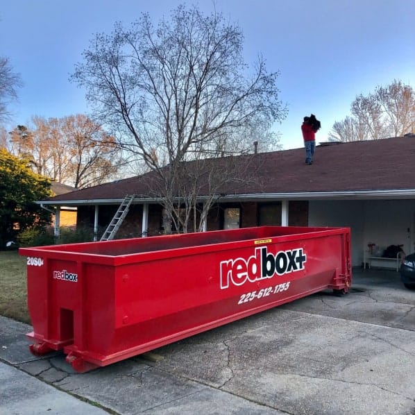 redbox+ Dumpsters of Baton Rouge dumpster in front of residential home