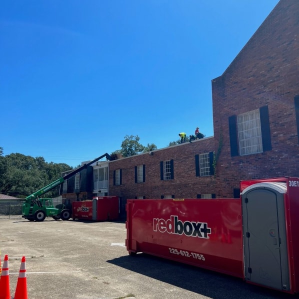 redbox+ Dumpsters of Baton Rouge dumpster rental at a commercial construction job site.