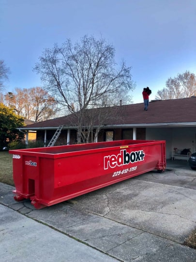 redbox+ Dumpsters of Baton Rouge dumpster in front of residential home