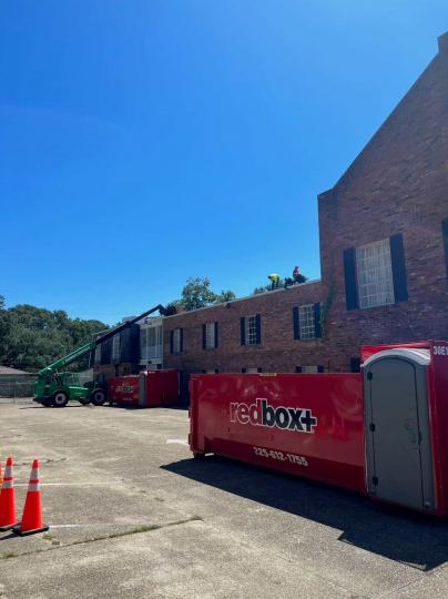 redbox+ Dumpsters of Baton Rouge dumpster rental at a commercial construction job site.