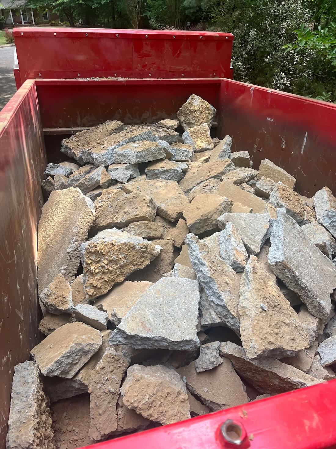 concrete demolition debris in a roll-off dumpster