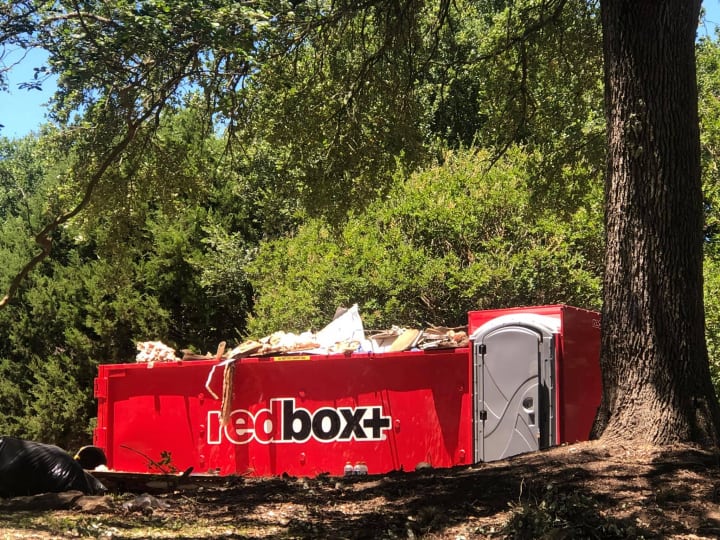 elite dumpster with porta potty