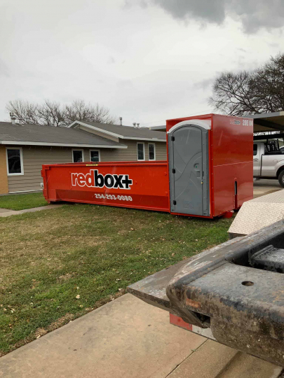 redbox+ Dumpsters of Central Texas elite dumpster in front of residential home