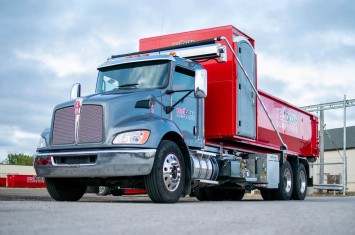 red roll off dumpster rental with a porta potty