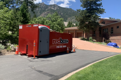a redbox plus dumpster out at a site
