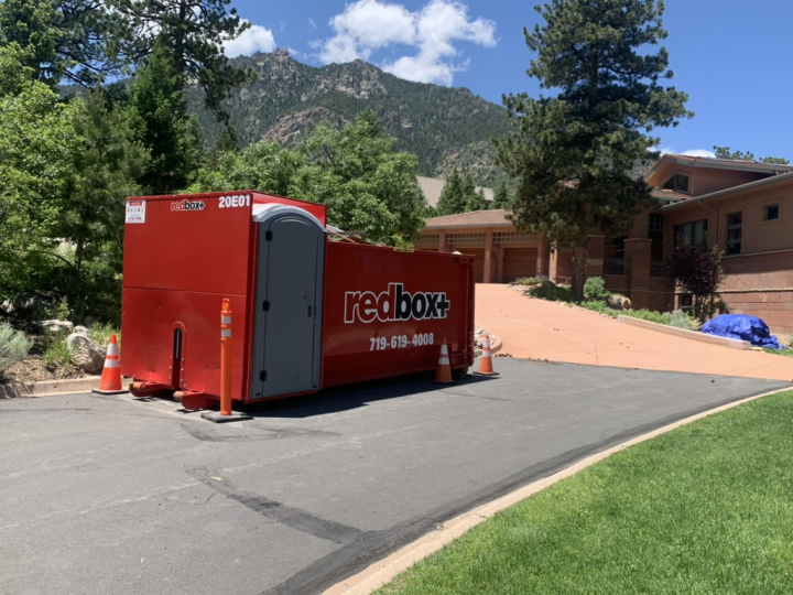 a redbox plus dumpster out at a site