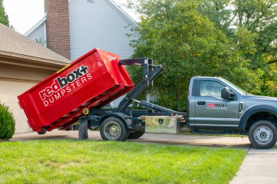 mini 10-yard dumpster being rolled off at a residential home