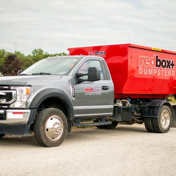 redbox+ Dumpsters of Denver South Metro residential mini dumpster on truck rental at a job site in Parker, CO