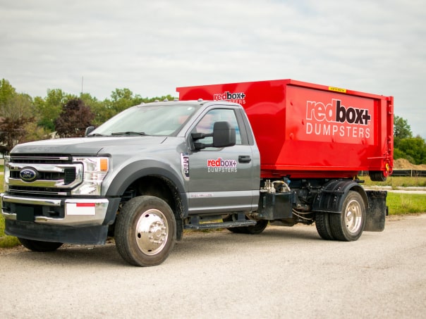 redbox+ Dumpsters of Denver South Metro residential mini dumpster on truck rental at a job site in Parker, CO
