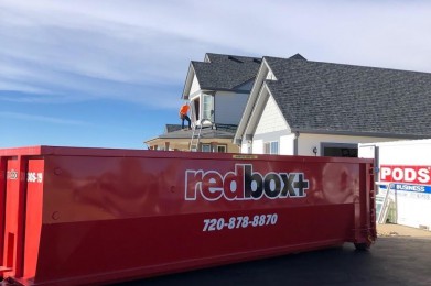 standard redbox+ dumpster in front of house