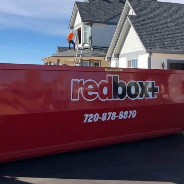 redbox+ Dumpsters of Denver South Metro roll-off dumpster placed in front of a home undergoing a roofing project.