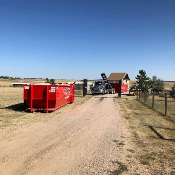 redbox+ Dumpsters of Denver South Metro roll-off dumpster placed in front of a home during a residential roofing project.