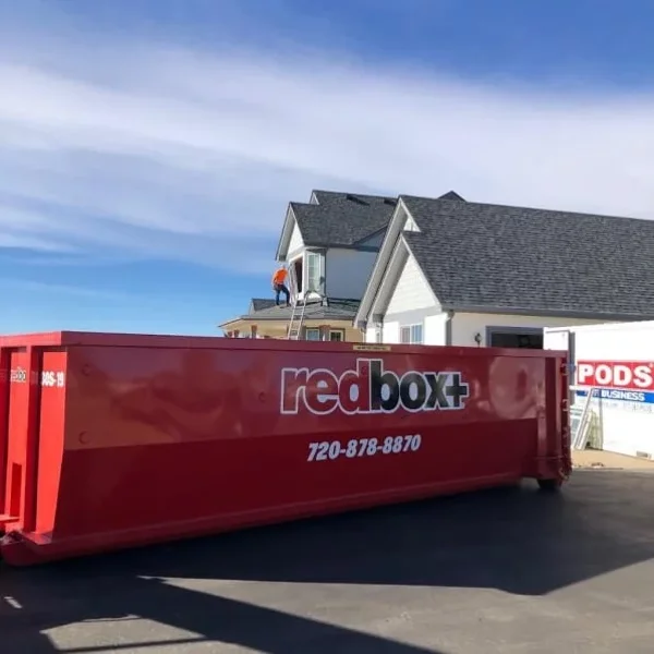 redbox+ Dumpsters of Denver South Metro roll-off dumpster placed in front of a home during a residential roofing project.