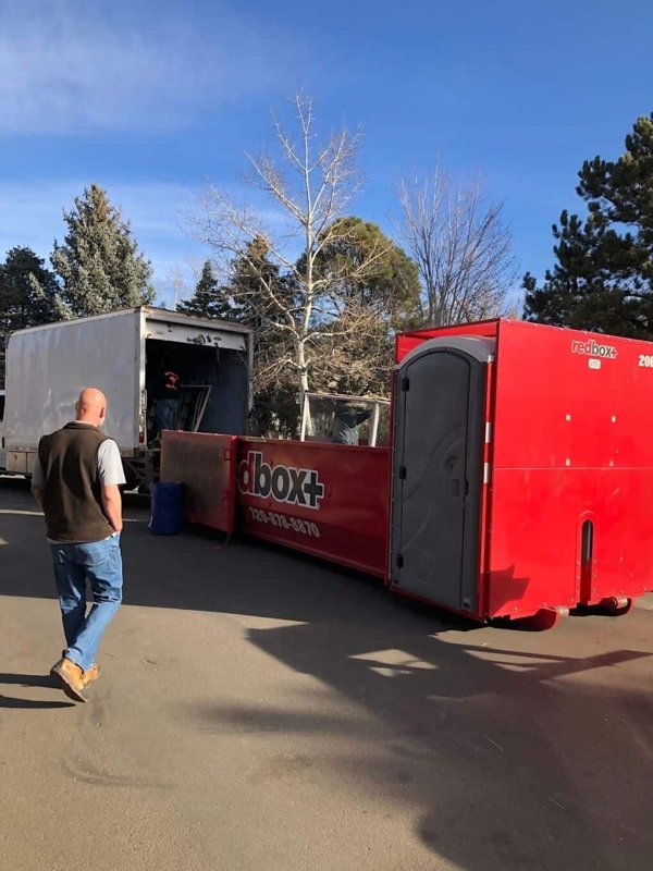 redbox+ Dumpsters of Denver South Metro Elite roll-off dumpster being delivered to a residential property.