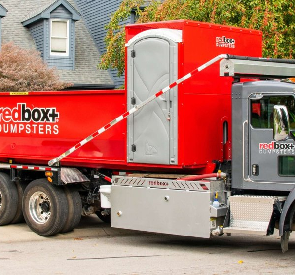 Redbox+ Dumpsters of Denver South Metro Elite roll-off dumpster rental truck parked in a residential neighborhood.
