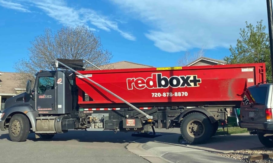 redbox+ Dumpsters of Denver South Metro 30-yard dumpster rental and truck arriving at a residential job site