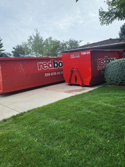redbox+ Dumpsters of Denver South Metro roll-off dumpsters placed on a residential driveway for a home renovation cleanup.