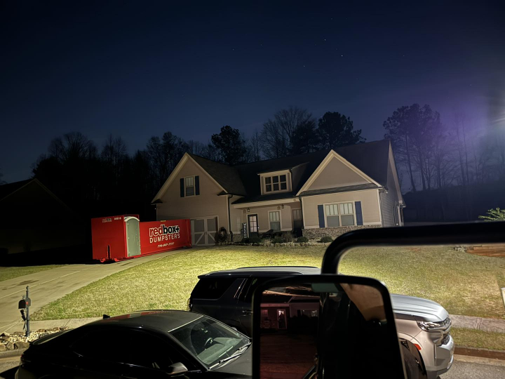 elite roll-off dumpster rental with a portable toilet at a residential project