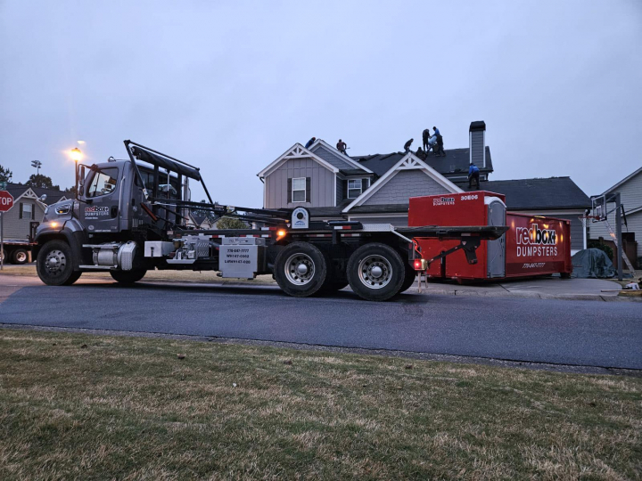 elite dumpster rental with portable toilet at a residential project