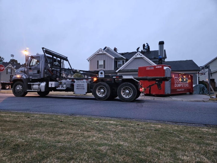 elite dumpster rental with portable toilet at a residential project