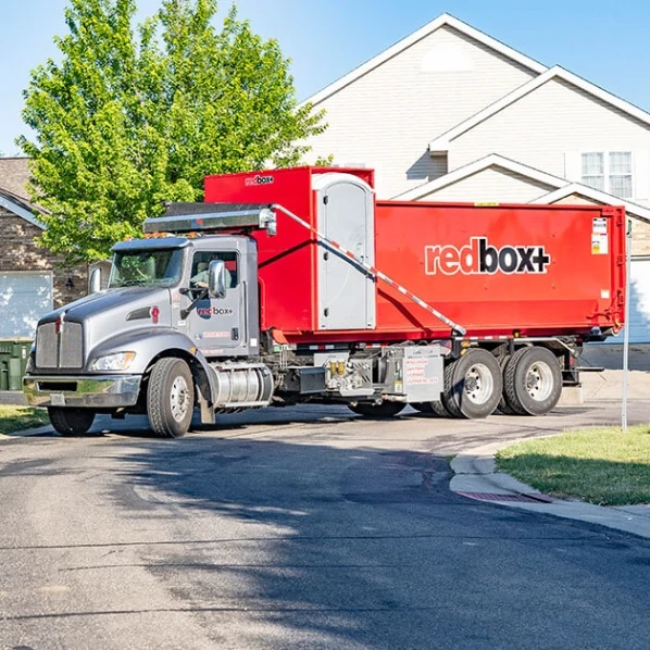 truck delivering dumpster rental