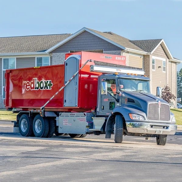 truck delivering dumpster rental