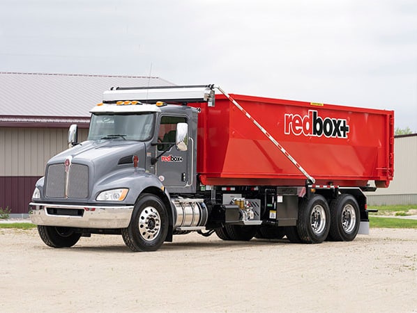 truck delivering dumpster rental in austin, tx