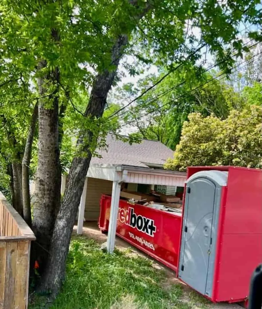 redbox+ Elite dumpster with built-in portable toilet at a home project
