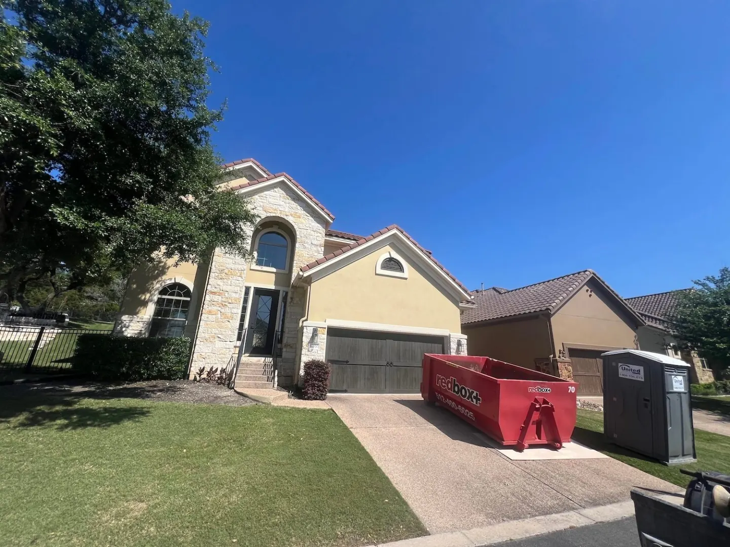 redbox+ dumpster placed in a residential driveway