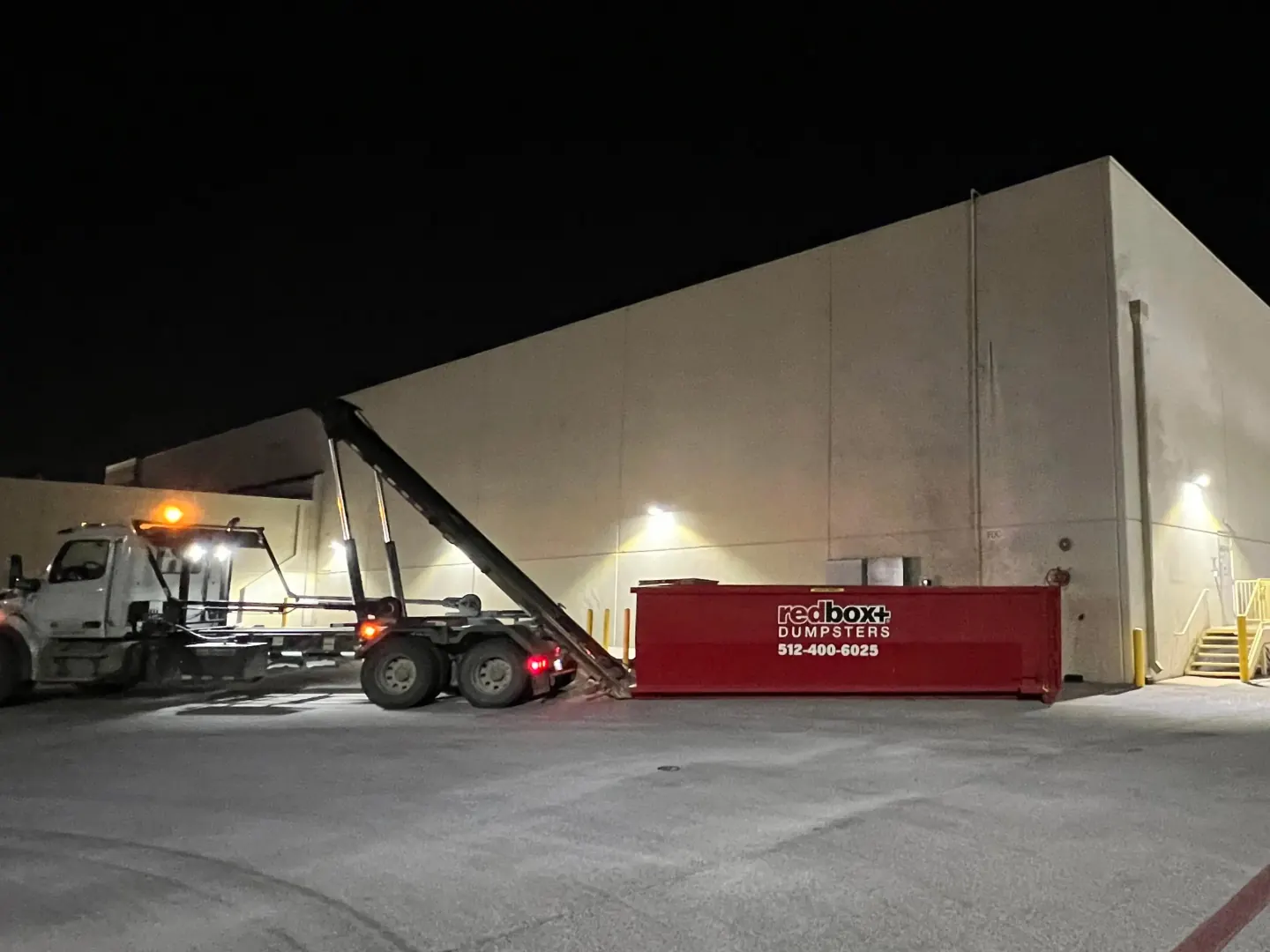 redbox+ night dumpster delivery at a warehouse