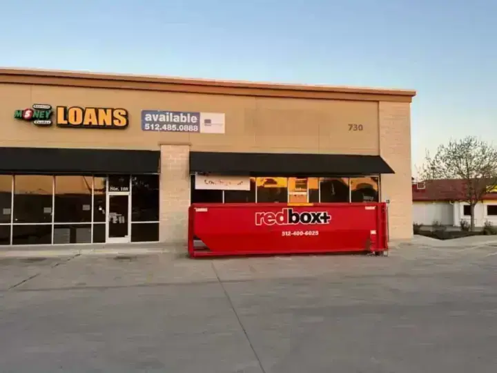 redbox+ dumpster outside a retail storefront