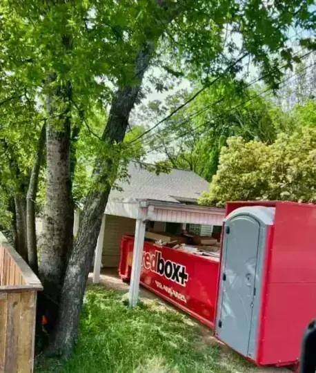 redbox+ Elite dumpster with built-in portable toilet at a home project