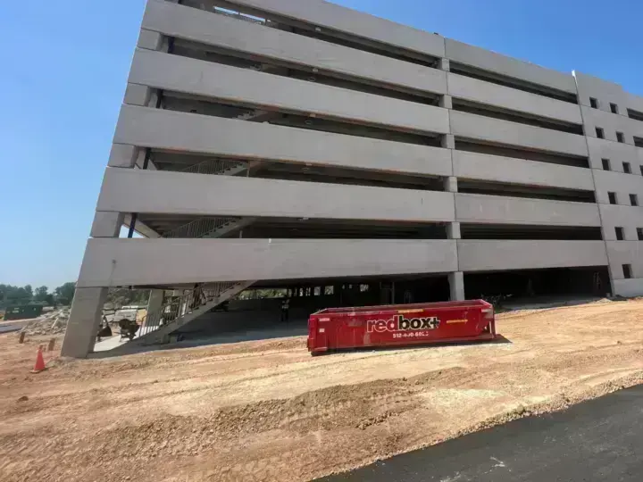redbox+ dumpster at a parking garage construction project