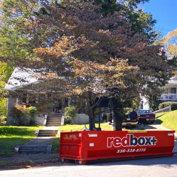 a standard dumpster outside of a home