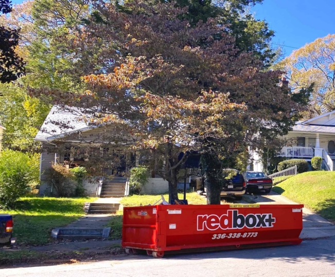 a standard dumpster outside of a home