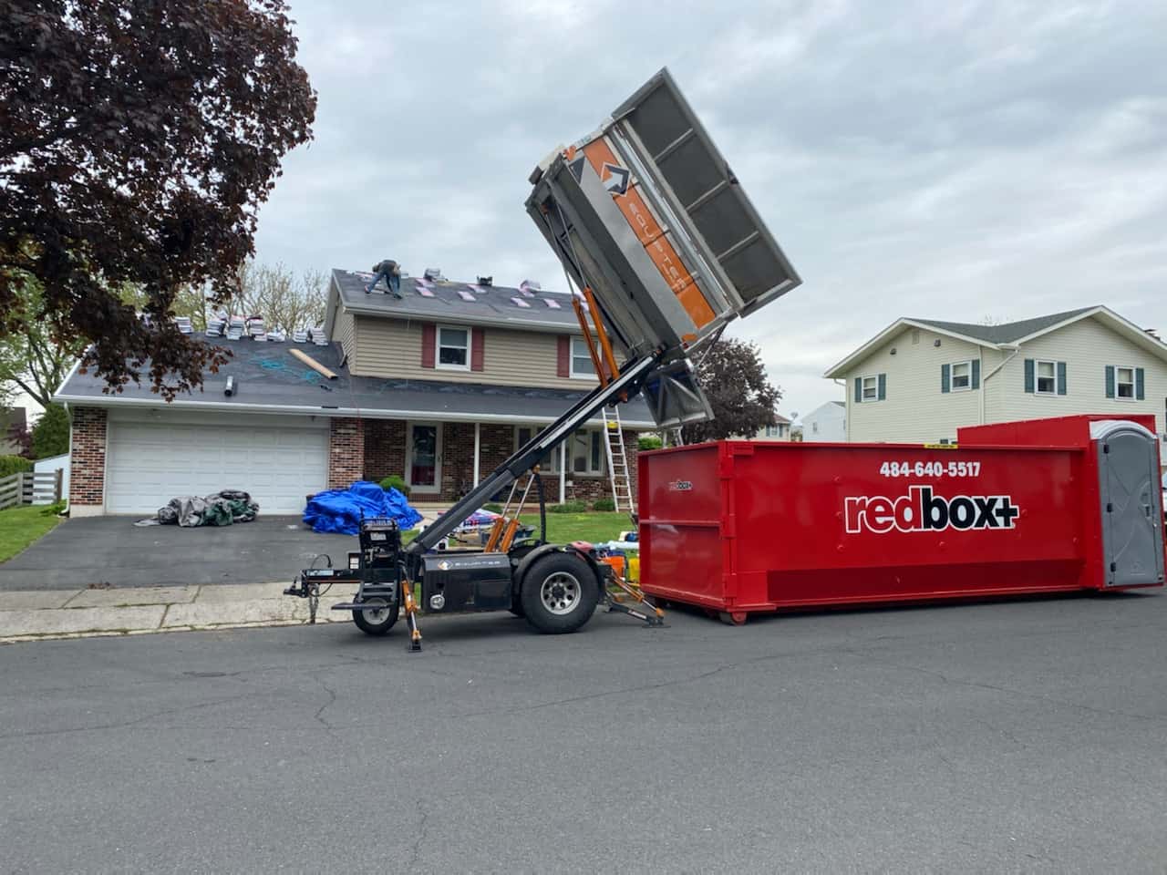a roofing dumpster rental at a job site