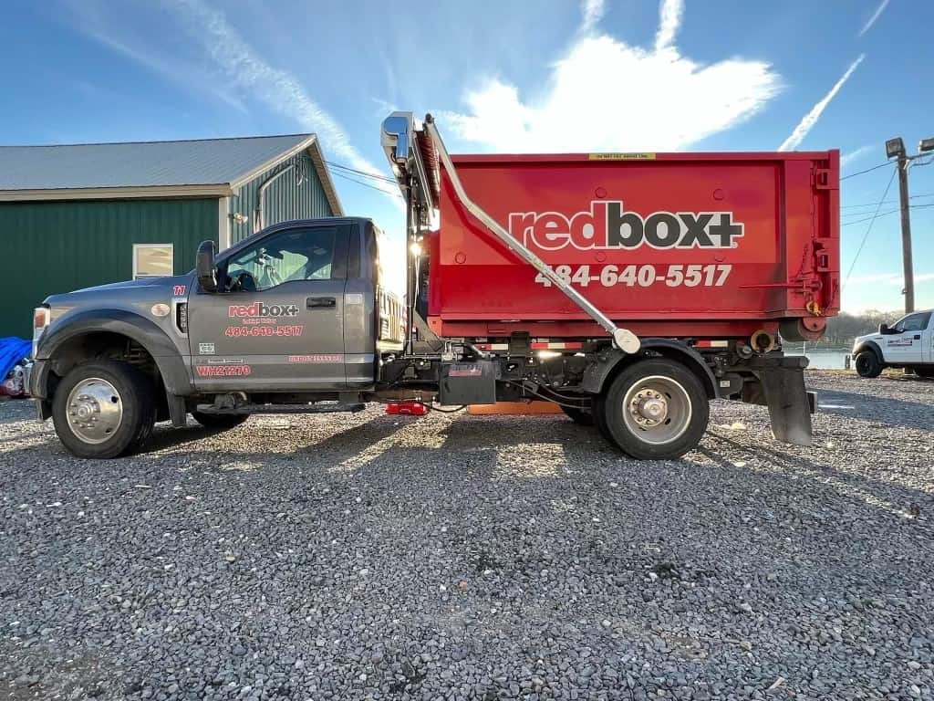 a 10-yard dumpster on our specialized truck ready to be delivered to a customer's job site