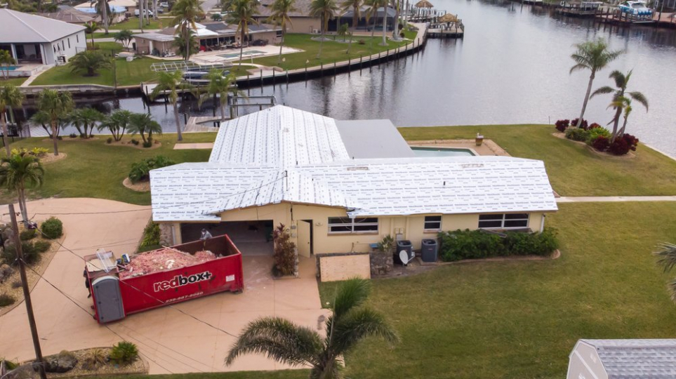 dumpster rental in Naples, FL in front of house