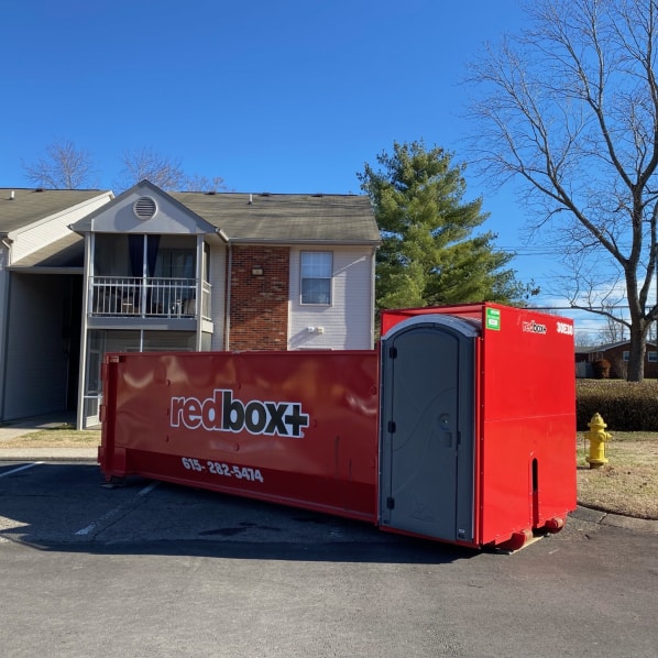elite dumpster with porta potty at a job site in Portland, TN
