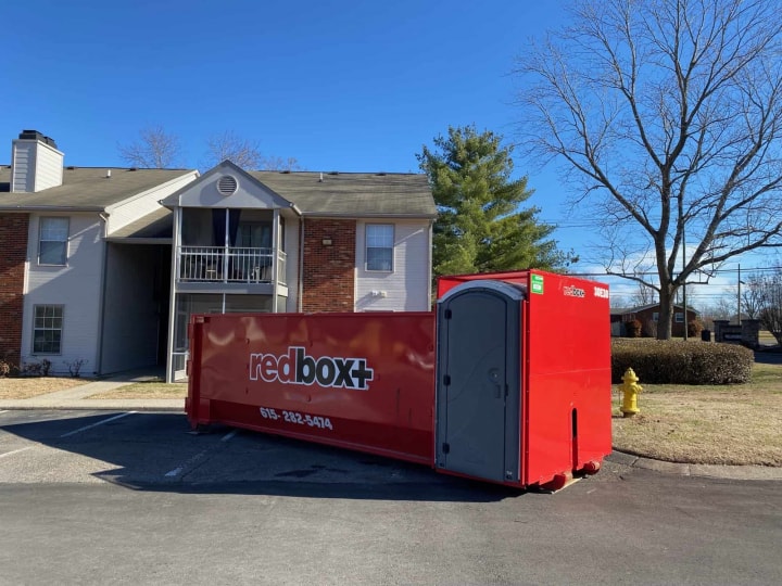 elite dumpster with porta potty at a job site in Portland, TN