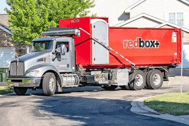 elite dumpster being delivered to residential job