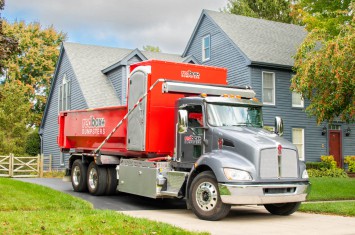 redbox+ Dumpsters of Northeast Atlanta truck and dumpster rental parked at residential job