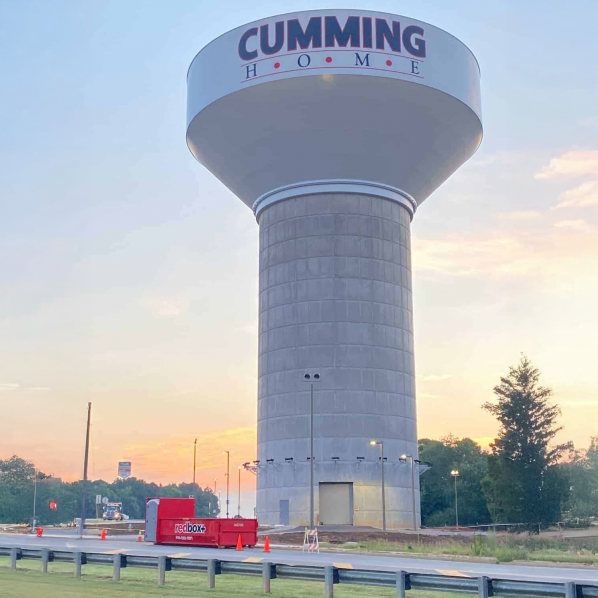 dumpster in front of water tower