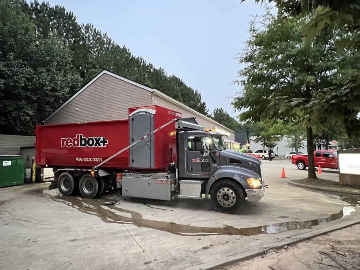redbox+ Dumpsters of Northeast Atlanta truck and 30-yard Elite dumpster rental at a job near Auburn, GA