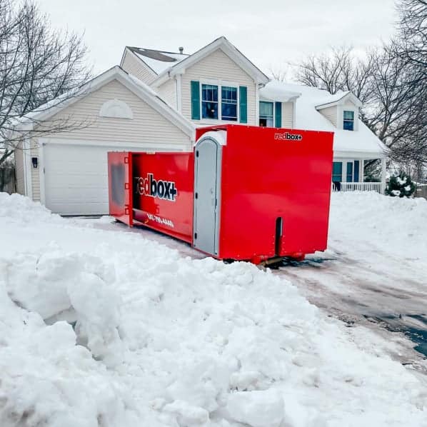 elite dumpster in driveway