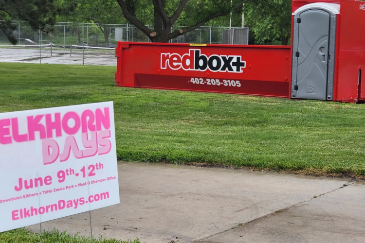 Redbox+ dumpster being delivered in an Omaha neighborhood for a home renovation project