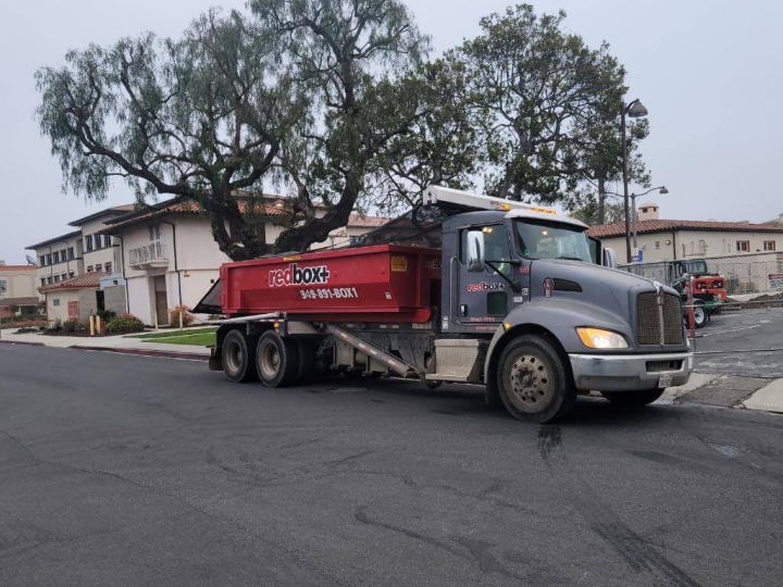 residential dumpster rental truck in orange county neighborhood